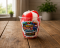 red and white water ice in clear Shai’s Philly 2TX branded cup on rustic farmhouse table with soft natural lighting, gourmet Philadelphia-style Italian ice dessert product photo.